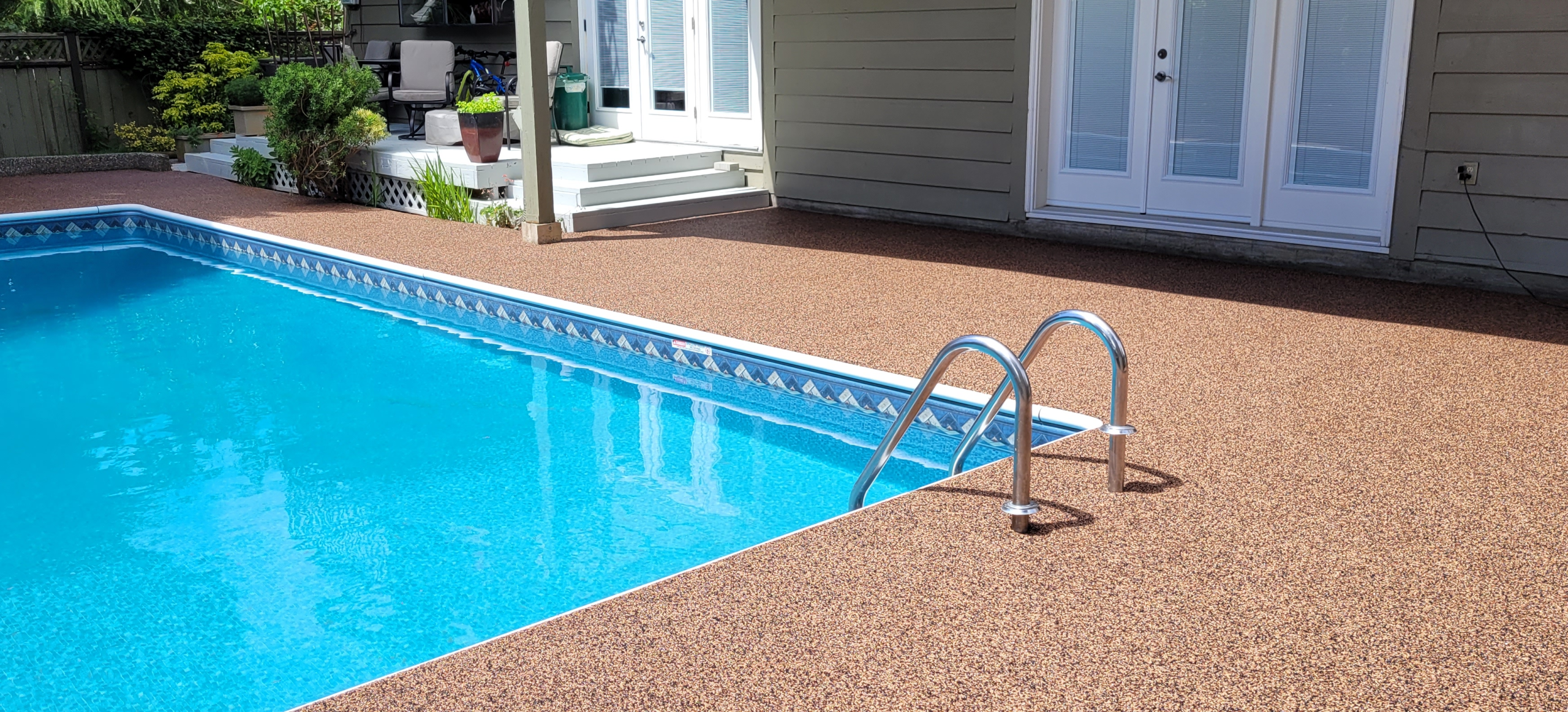 Beige, brown and black rubber paved pool deck, Langley, BC